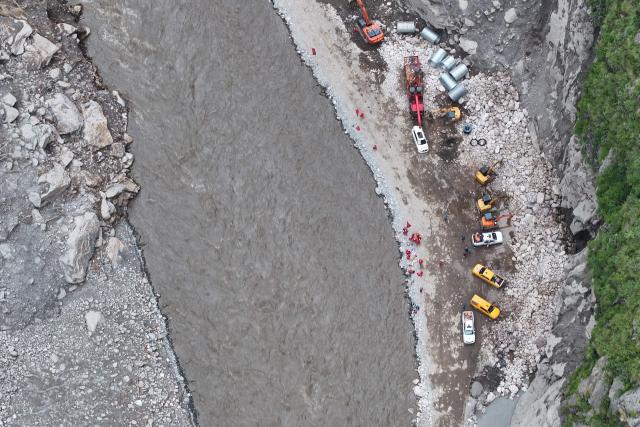 This aerial photo shows excavators rebuilding the road which leads to the destroyed Gyirong Port in Gyirong County, in China’s western Tibet region on September 1, 2026. The first batch of emergency machinery, including excavators, arrived at the search-and-rescue zone at the site of Gyirong Port on September 1. (Photo by CNS / AFP) / China OUT