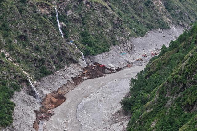 This aerial photo shows excavators working to carve a route towards the destroyed Gyirong Port in Gyirong County, in China’s western Tibet region on September 1, 2026. The first batch of emergency machinery, including excavators, arrived at the search-and-rescue zone at the site of Gyirong Port on September 1. (Photo by CNS / AFP) / China OUT