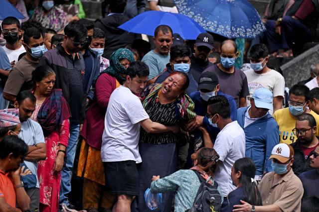 Relatives mourn during symbolic funerals held for flood victims still reported missing as they cremate Kush grass effigies in accordance with Nepali Hindu rites at Pashupatinath temple in Kathmandu on September 2, 2026. Nepali families were holding symbolic funeral ceremonies to "liberate the souls" of loved ones missing since deadly flash floods swept away their villages and homes in the Himalayan region a week ago. (Photo by PRAKASH MATHEMA / AFP)