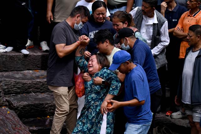 Relatives mourn during symbolic funerals held for flood victims still reported missing as they cremate Kush grass effigies in accordance with Nepali Hindu rites at Pashupatinath temple in Kathmandu on September 2, 2026. Nepali families were holding symbolic funeral ceremonies to "liberate the souls" of loved ones missing since deadly flash floods swept away their villages and homes in the Himalayan region a week ago. (Photo by PRAKASH MATHEMA / AFP)