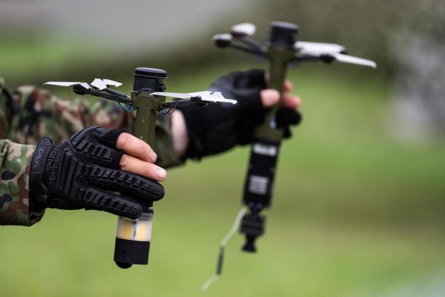 A member of the Japan Ground Self-Defense Force (JGSDF) 6th Division (20th Infantry Regiment) shows off handheld surveillance and ordnance drones during an exercise covering drone and suppression operations, part of the “Brunet-Takamori 26 (BT26)” Japan-France joint military exercises, at the Ojoji-ga-hara training area near Osaki, Miyagi Prefecture on September 2, 2026. (Photo by ANDREW CABALLERO-REYNOLDS / AFP)