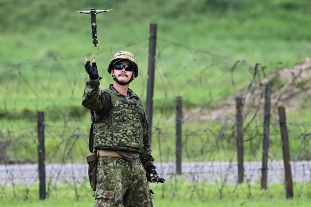 A member of the Japan Ground Self-Defense Force (JGSDF) 6th Division (20th Infantry Regiment) launches a handheld surveillance drone during an exercise covering drone and suppression operations, part of the “Brunet-Takamori 26 (BT26)” Japan-France joint military exercises, at the Ojoji-ga-hara training area near Osaki, Miyagi Prefecture on September 2, 2026. (Photo by ANDREW CABALLERO-REYNOLDS / AFP)