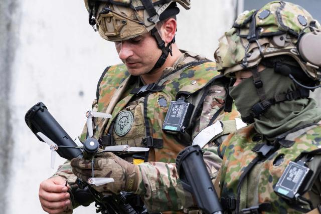 Members of the French Army New Caledonia Marine Infantry Regiment look at a handheld drone after an exercise covering drone and suppression operations, part of the “Brunet-Takamori 26 (BT26)” Japan-France joint military exercises, at the Ojoji-ga-hara training area near Osaki, Miyagi Prefecture on September 2, 2026. (Photo by ANDREW CABALLERO-REYNOLDS / AFP)