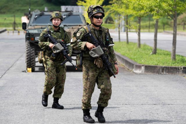 Japan Ground Self-Defense Force (JGSDF) members from the 6th Division (20th Infantry Regiment) walk through a training area before the start of an exercise covering drone and suppression operations, part of the “Brunet-Takamori 26 (BT26)” Japan-France joint military exercises, at the Ojoji-ga-hara training area near Osaki, Miyagi Prefecture on September 2, 2026. (Photo by ANDREW CABALLERO-REYNOLDS / AFP)