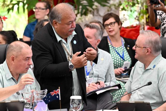 Pacific Islands Forum Secretary General Baron Waqa (C) talks with Australia's Prime Minister Anthony Albanese (R) as Cook Islands Prime Minister Mark Brown (L) looks on during the Pacific Islands Forum leaders' plenary meeting in Koror on September 2, 2026. (Photo by SAEED KHAN / AFP)