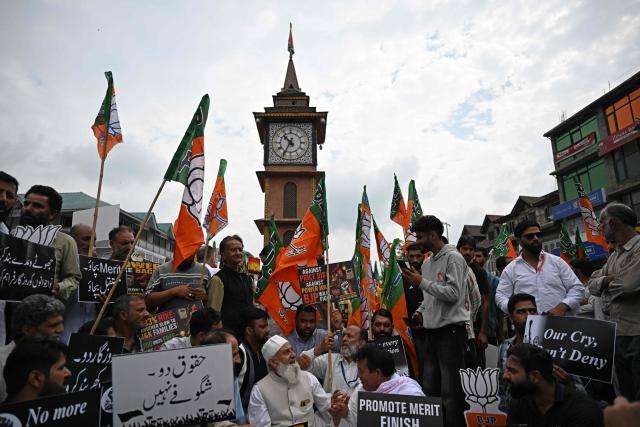 Bharatiya Janata Party (BJP) supporters hold placards during a protest against the state government in Srinagar on September 2, 2026. (Photo by TAUSEEF MUSTAFA / AFP)