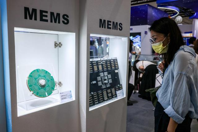 A visitor looks at MEMS (micro-electromechanical systems) components on display at the booth of ProbeLeader Co., Ltd, a Taiwanese company specialising in testing solutions and probe cards, during SEMICON Taiwan in Taipei on September 2, 2026. (Photo by I-Hwa Cheng / AFP)