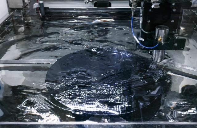 A silicon wafer undergoes acoustic inspection using equipment by US company Nordson during SEMICON Taiwan in Taipei on September 2, 2026. (Photo by I-Hwa Cheng / AFP)