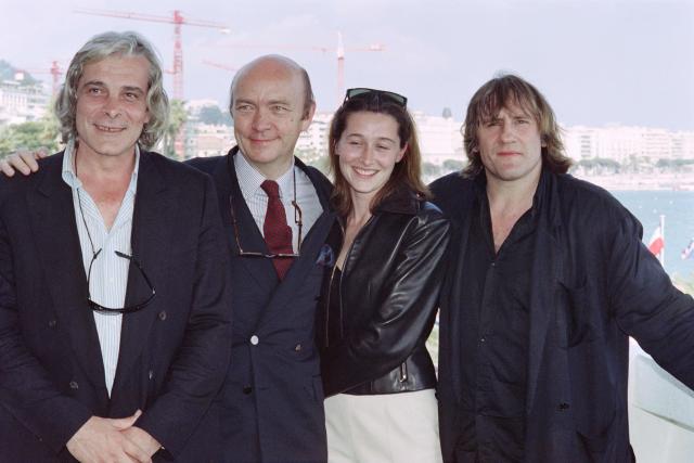 (FILES) (From L to R), French actor Jacques Weber, French director Jean-Paul Rappeneau, French actress Anne Brochet and French actor Gerard Depardieu pose during a photocall for the movie "Cyrano de Bergerac" at the 43th edition of the Cannes Film Festival, in Cannes, southern France on May 19, 1990. French filmmaker Jean-Paul Rappeneau, the multi-César-winning director of eight feature films, including "Cyrano de Bergerac" (1990), died in Paris on September 1, 2026 at the age of 94, one of his sons announced to AFP on September 2, 2026. (Photo by Gerard JULIEN and Jacques DEMARTHON / AFP)