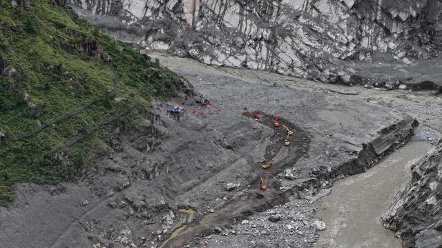 This aerial photo shows rescuers at the site of the Gyirong Port, which was destroyed by a mudslide on August 26, in Gyirong County, in China’s western Tibet region on September 2, 2026. (Photo by CNS / AFP) / China OUT