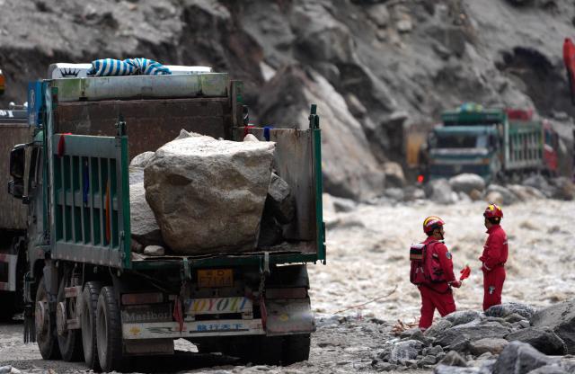 Trucks carrying stones are seen at the road clearing site as rescue personnel work to restore access to the mudslide-hit Gyirong Port in Gyirong County, in China's western Tibet Autonomous Region, on September 2, 2026. (Photo by CNS / AFP) / China OUT