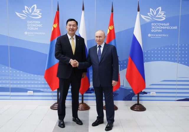 In this pool photograph distributed by the Russian state agency Sputnik, Russia's President Vladimir Putin meets with Mongolia's Prime Minister Nyam-Osor Uchral on the sidelines of the Eastern Economic Forum in Vladivostok on September 2, 2026. (Photo by Vyacheslav PROKOFYEV / POOL / AFP)