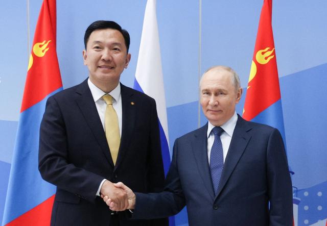 In this pool photograph distributed by the Russian state agency Sputnik, Russia's President Vladimir Putin meets with Mongolia's Prime Minister Nyam-Osor Uchral on the sidelines of the Eastern Economic Forum in Vladivostok on September 2, 2026. (Photo by Vyacheslav PROKOFYEV / POOL / AFP)