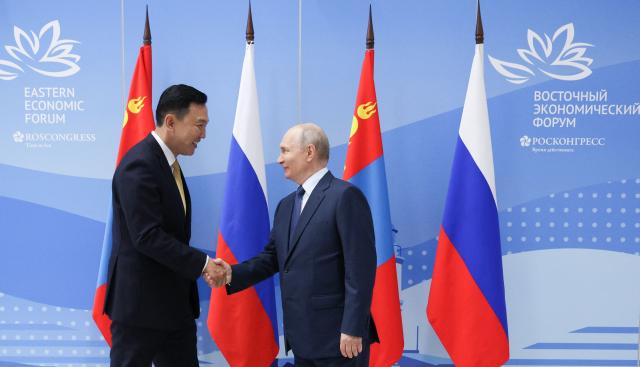 In this pool photograph distributed by the Russian state agency Sputnik, Russia's President Vladimir Putin meets with Mongolia's Prime Minister Nyam-Osor Uchral on the sidelines of the Eastern Economic Forum in Vladivostok on September 2, 2026. (Photo by Vyacheslav PROKOFYEV / POOL / AFP)