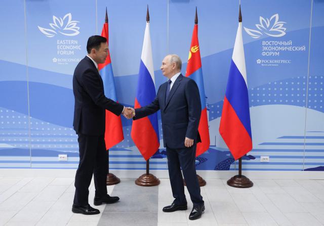 In this pool photograph distributed by the Russian state agency Sputnik, Russia's President Vladimir Putin meets with Mongolia's Prime Minister Nyam-Osor Uchral on the sidelines of the Eastern Economic Forum in Vladivostok on September 2, 2026. (Photo by Vyacheslav PROKOFYEV / POOL / AFP)