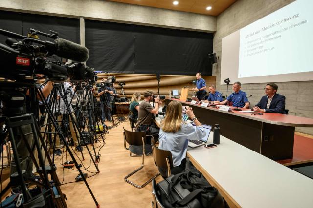 Aargau Canton Police Commander Michael Leupold (C) speaks during a press conference following a shooting at a rave party in Aarau, in Schafisheim, northern Switzerland on September 2, 2026. A 43-year-old Swiss man was arrested on August 2, 2026 on "strong suspicion" of being behind a rare deadly gun attack at a rave in Switzerland, police said. The attack triggered an international manhunt for the shooter, who left an Italian woman dead and wounded five others, some seriously. (Photo by Fabrice COFFRINI / AFP)