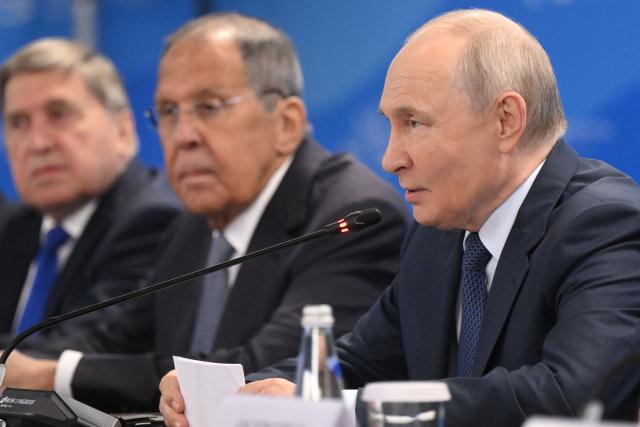 In this pool photograph distributed by the Russian state agency Sputnik, Russia's President Vladimir Putin, accompanied by Kremlin foreign policy adviser Yuri Ushakov and Foreign Minister Sergei Lavrov, attends a meeting with Mongolia's Prime Minister on the sidelines of the Eastern Economic Forum in Vladivostok on September 2, 2026. (Photo by Kristina Solovyova / POOL / AFP)