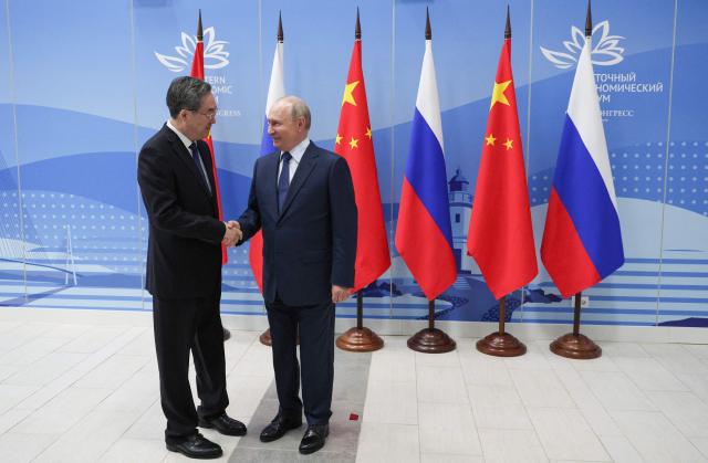 In this pool photograph distributed by the Russian state agency Sputnik, Russia's President Vladimir Putin and Chinese Vice Premier Ding Xuexiang shake hands during a meeting on the sidelines of the Eastern Economic Forum in Vladivostok on September 2, 2026. (Photo by Vyacheslav PROKOFYEV / POOL / AFP)