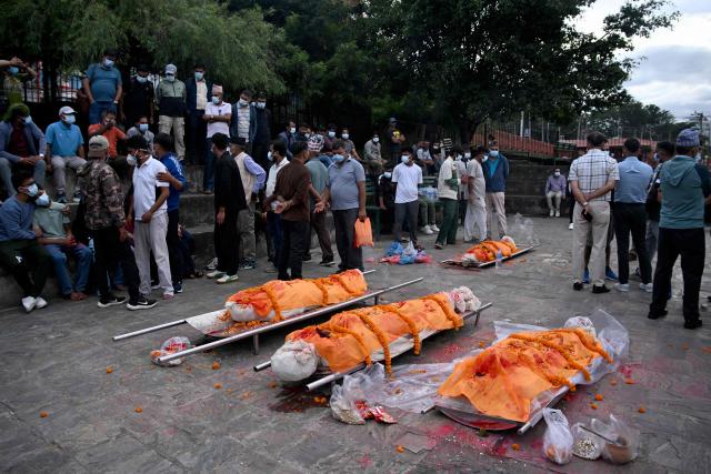 Family members mourn during the funeral rites of flash flood victims before their cremation at Pashupatinath temple in Kathmandu on September 2, 2026. Devastating floods on the China-Nepal border killed at least 1,204 people in Nepal, with 4,216 still missing, the disaster authority said on September 2, a week after the disaster. (Photo by Prakash MATHEMA / AFP)