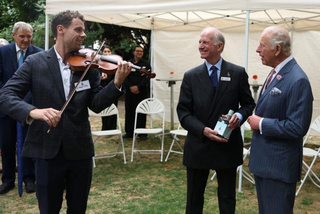John Steel, chairman of the Victoria League for Commonwealth Friendship, presents Britain's King Charles with a commemorative bottle of gin during the 125th anniversary Garden Party for, the Victoria League for Commonwealth Friendship, in west London, on September 2, 2026. (Photo by Toby Melville / POOL / AFP)
