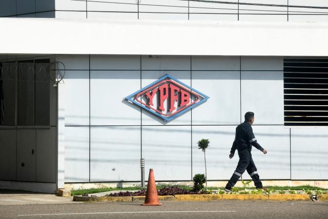 (FILES) A worker walks at the Guillermo Elder Bell refinery headquarters of Bolivian state-owned oil company YPFB in Santa Cruz, Bolivia, on December 5, 2025. The Bolivian government ordered temporary intervention of the state-owned oil company YPFB in order to "restore efficiency" to its management, amid a fuel supply crisis, according to a decree published in the official gazette on September 2, 2026. (Photo by Rodrigo URZAGASTI / AFP)