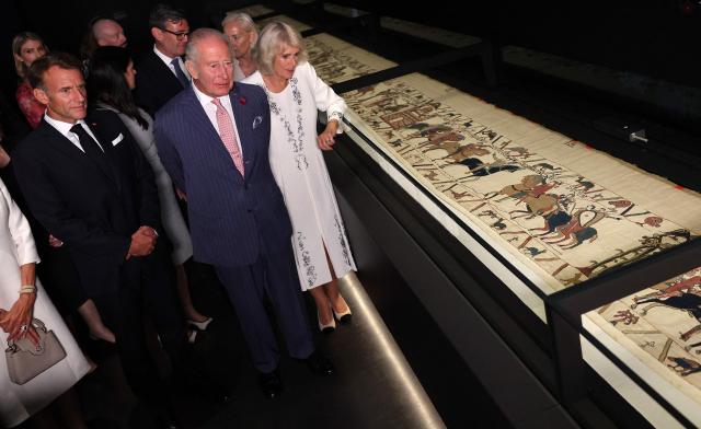 Britain's King Charles III and Britain's Queen Camilla alongside France's President Emmanuel Macron view a section of the Bayeux Tapestry, during a preview event for the Bayeux Tapestry Exhibition, at the British Museum in London on September 2, 2026. (Photo by Adrian Dennis / POOL / AFP)