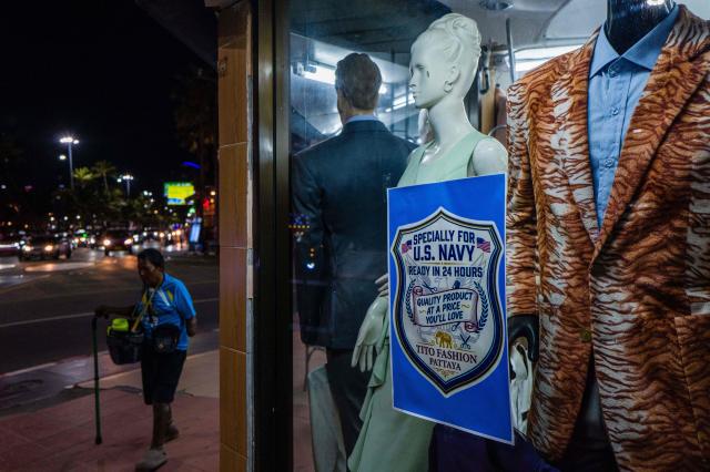 A pedestrian walks past a shop with a special discount for US service personnel of the nuclear-powered aircraft carrier USS Abraham Lincoln (CVN-72) in Pattaya on September 2, 2026. (Photo by ANTHONY WALLACE / AFP)