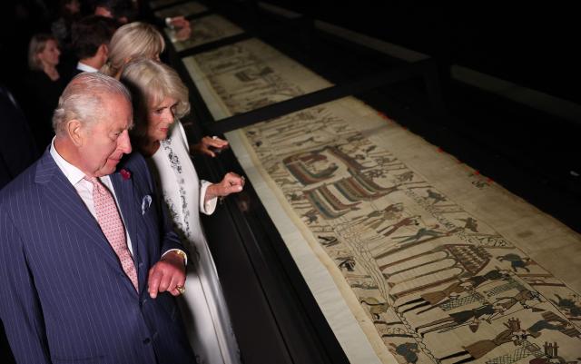 Britain's King Charles III and Britain's Queen Camilla, accompanied by France's President Emmanuel Macron and his wife Brigitte Macron (obscured) view sections of the Bayeux Tapestry during a preview event for the Bayeux Tapestry Exhibition, at the British Museum in London on September 2, 2026. (Photo by Adrian Dennis / POOL / AFP)