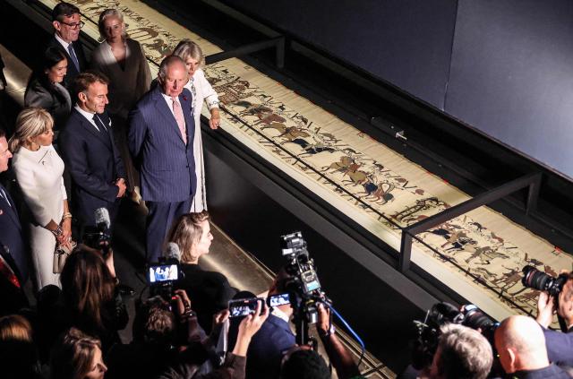 Britain's King Charles III and Britain's Queen Camilla alongside France's President Emmanuel Macron and his wife Brigitte Macron, and Britain's Prime Minister Andy Burnham, attend a preview event for the Bayeux Tapestry Exhibition, at the British Museum in London on September 2, 2026. (Photo by Richard Pohle / POOL / AFP)