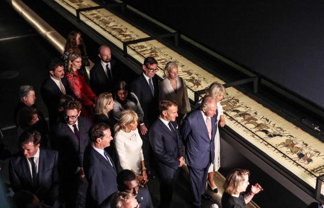 Britain's King Charles III and Britain's Queen Camilla alongside France's President Emmanuel Macron and his wife Brigitte Macron, and Britain's Prime Minister Andy Burnham, attend a preview event for the Bayeux Tapestry Exhibition, at the British Museum in London on September 2, 2026. (Photo by Richard Pohle / POOL / AFP)