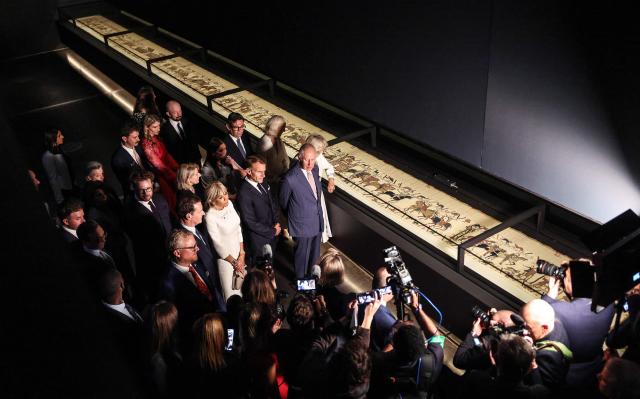Britain's King Charles III and Britain's Queen Camilla alongside France's President Emmanuel Macron and his wife Brigitte Macron, and Britain's Prime Minister Andy Burnham, attend a preview event for the Bayeux Tapestry Exhibition, at the British Museum in London on September 2, 2026. (Photo by Richard Pohle / POOL / AFP)