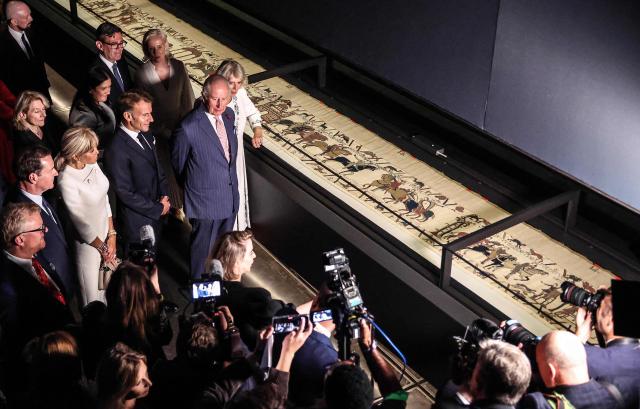 Britain's King Charles III and Britain's Queen Camilla alongside France's President Emmanuel Macron and his wife Brigitte Macron, and Britain's Prime Minister Andy Burnham, attend a preview event for the Bayeux Tapestry Exhibition, at the British Museum in London on September 2, 2026. (Photo by Richard Pohle / POOL / AFP)