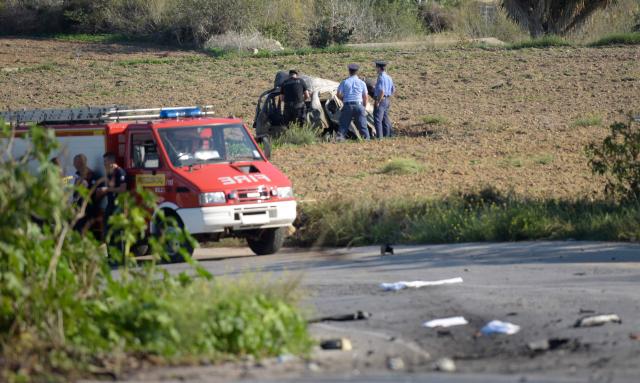 (FILES) Police inspect the wreckage of a car bomb believed to have killed journalist and blogger Daphne Caruana Galizia close to her home in Bidnija, Malta? on October 16, 2017. The force of the blast broke her car into several pieces and catapulted the journalist's body into a nearby field, witnesses said. She leaves a husband and three sons. A Maltese court on September 2, 2026 aquitted tycoon Yorgen Fenech of orchestrating the brutal murder in 2017 of investigative reporter Daphne Caruana Galizia, according to media reports. (Photo by AFP) / Malta OUT