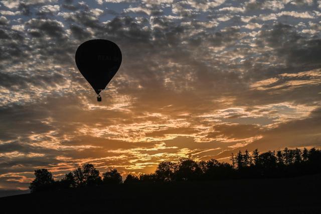 A Hot-air balloon is seen as the sun goes down during the hot air balloon Fiesta on September 2, 2026 in Hradec Kralove city, Czech Republic. (Photo by Michal Cizek / AFP)
