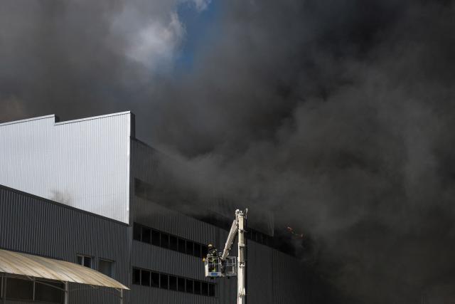 Ukrainian rescue personnel extinguish a fire in an auto parts warehouse following an air attack in Kyiv on September 2, 2026, amid the Russian invasion of Ukraine. (Photo by Vladyslav Musiienko / AFP)