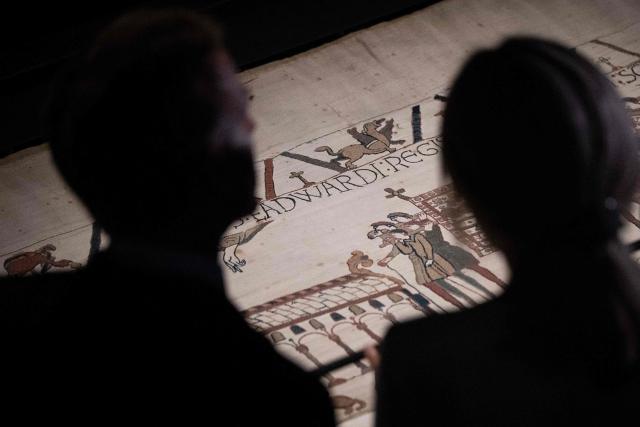 President Emmanuel Macron (L) and his wife Brigitte Macron (R) view sections of the Bayeux Tapestry during a preview event for the Bayeux Tapestry Exhibition, at the British Museum in London on September 2, 2026. (Photo by Jeanne Accorsini / POOL / AFP)