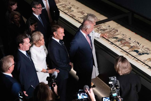 Britain's King Charles III (2R) and Britain's Queen Camilla (R) alongside France's President Emmanuel Macron (C) and his wife Brigitte Macron (3L) and British Museum Chairman George Osborne (2L) view sections of the Bayeux Tapestry during a preview event for the Bayeux Tapestry Exhibition, at the British Museum in London on September 2, 2026. (Photo by Jeanne Accorsini / POOL / AFP)