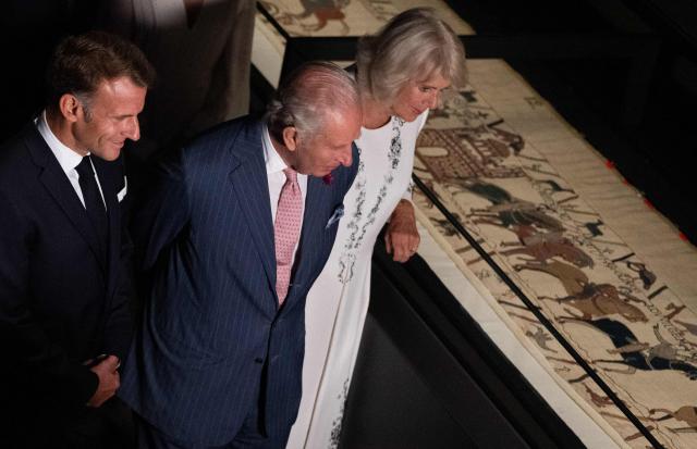 France's President Emmanuel Macron (L), Britain's King Charles III (C) and Britain's Queen Camilla (R) views sections of the Bayeux Tapestry during a preview event for the Bayeux Tapestry Exhibition, at the British Museum in London on September 2, 2026. (Photo by Jeanne Accorsini / POOL / AFP)