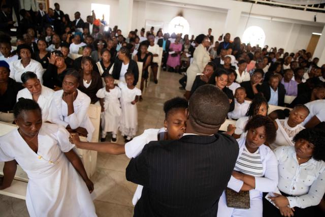 People mourn during a collective funeral service for more than twenty people killed by armed gangs last week in Kenscoff, a neighborhood near Port-au-Prince, on September 2, 2026. Gang members attacked displaced people huddling inside a church near Haiti's capital, killing around 40, some of them execution-style, the mayor told AFP on August 24. (Photo by Clarens SIFFROY / AFP)