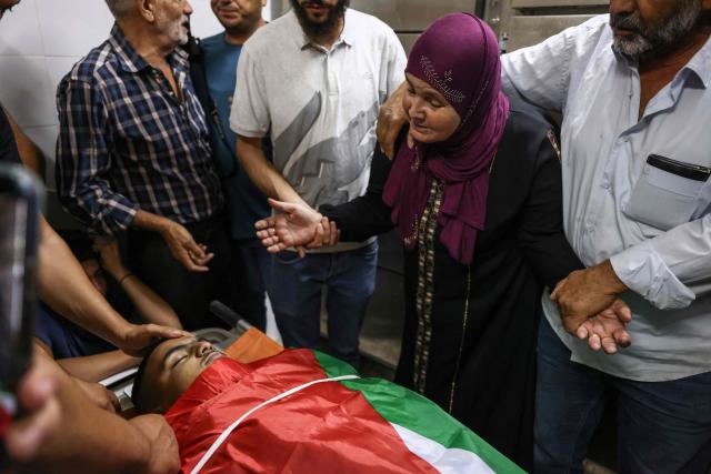 The grandmother of Khalil Rasem Khalil Shehadeh mourns over the body of one of two Palestinians killed in Al-Mughayyir, east of Ramallah, at Ramallah government hospital, after an Israeli settler attack followed by an Israeli army raid, in the occupied West Bank on September 2, 2026. Violence by Israeli settlers towards Palestinians in the West Bank has persisted for years, often with little or no legal consequence, but recent months have seen a surge in attacks. More than 500,000 Israelis live in settlements in the Palestinian territory, which are illegal under international law, among some three million Palestinians. Israel has occupied the West Bank since 1967. (Photo by Zain JAAFAR / AFP)