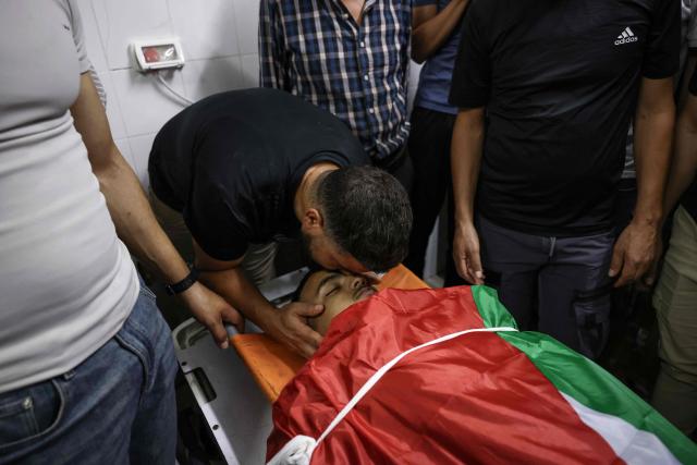 A relative mourns over the body of one of two Palestinians killed in Al-Mughayyir, east of Ramallah, at Ramallah government hospital, after an Israeli settler attack followed by an Israeli army raid, in the occupied West Bank on September 2, 2026. Violence by Israeli settlers towards Palestinians in the West Bank has persisted for years, often with little or no legal consequence, but recent months have seen a surge in attacks. More than 500,000 Israelis live in settlements in the Palestinian territory, which are illegal under international law, among some three million Palestinians. Israel has occupied the West Bank since 1967. (Photo by Zain JAAFAR / AFP)