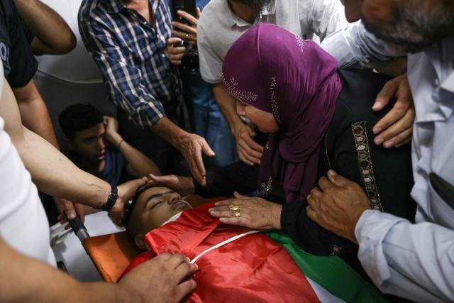 A relative mourns over the body of one of two Palestinians killed in Al-Mughayyir, east of Ramallah, at Ramallah government hospital, after an Israeli settler attack followed by an Israeli army raid, in the occupied West Bank on September 2, 2026. Violence by Israeli settlers towards Palestinians in the West Bank has persisted for years, often with little or no legal consequence, but recent months have seen a surge in attacks. More than 500,000 Israelis live in settlements in the Palestinian territory, which are illegal under international law, among some three million Palestinians. Israel has occupied the West Bank since 1967. (Photo by Zain JAAFAR / AFP)