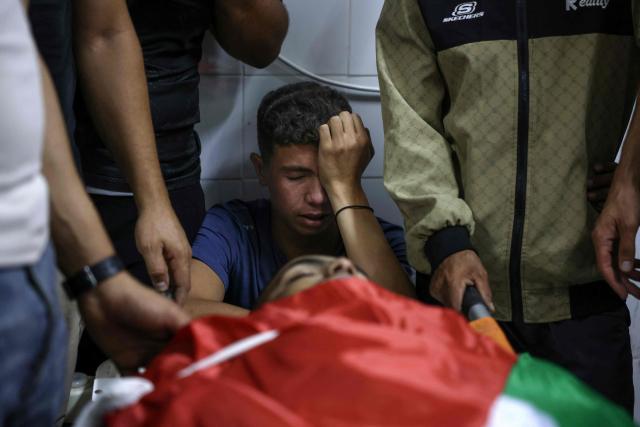Relatives of Khalil Rasem Khalil Shehadeh mourn over the body of one of two Palestinians killed in Al-Mughayyir, east of Ramallah, at Ramallah government hospital, after an Israeli settler attack followed by an Israeli army raid, in the occupied West Bank on September 2, 2026. Violence by Israeli settlers towards Palestinians in the West Bank has persisted for years, often with little or no legal consequence, but recent months have seen a surge in attacks. More than 500,000 Israelis live in settlements in the Palestinian territory, which are illegal under international law, among some three million Palestinians. Israel has occupied the West Bank since 1967. (Photo by Zain JAAFAR / AFP)