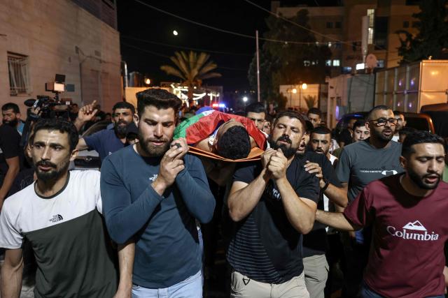 Mourners carry the body of one of two Palestinians killed in Al-Mughayyir, east of Ramallah, at Ramallah government hospital, after an Israeli settler attack followed by an Israeli army raid, in the occupied West Bank on September 2, 2026. Violence by Israeli settlers towards Palestinians in the West Bank has persisted for years, often with little or no legal consequence, but recent months have seen a surge in attacks. More than 500,000 Israelis live in settlements in the Palestinian territory, which are illegal under international law, among some three million Palestinians. Israel has occupied the West Bank since 1967. (Photo by Zain JAAFAR / AFP)