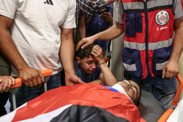 Relatives of Khalil Rasem Khalil Shehadeh mourn over his body during  the funeral of two Palestinians killed in Al-Mughayyir, east of Ramallah, following an Israeli settler attack and subsequent Israeli army raid, at the Ramallah Government Hospital in the occupied West Bank on September 2, 2026. Violence by Israeli settlers towards Palestinians in the West Bank has persisted for years, often with little or no legal consequence, but recent months have seen a surge in attacks. More than 500,000 Israelis live in settlements in the Palestinian territory, which are illegal under international law, among some three million Palestinians. Israel has occupied the West Bank since 1967. (Photo by Zain JAAFAR / AFP)