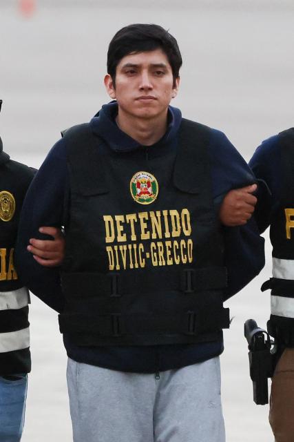 Jhonsson Smit Cruz Torres, leader of the feared criminal organization "Los Pulpos" and one of Peru's most wanted men, arrives escorted by Peruvian Police officers at Group 8 of the Peruvian Air Force in El Callao, Lima, on September 2, 2026, after being extradited from Bolivia. Known as "John Pulpo", the 30-year-old man was sentenced to life imprisonment for murdering a trader during a robbery in Trujillo, Peru, in 2020. (Photo by Connie FRANCE / AFP)