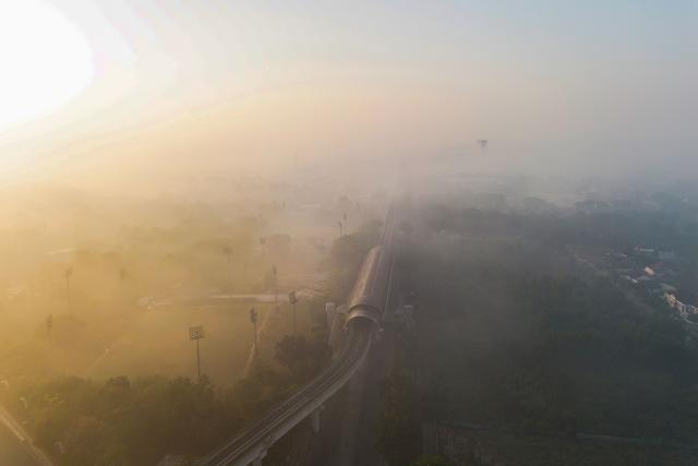 An aerial drone view shows Light Rail Transit route shrouded in haze caused by forest fires in Palembang, North Sumatra on September 3, 2026. (Photo by AL ZULKIFLI / AFP)
