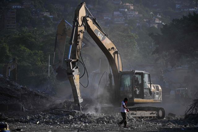 Heavy machinery clears the rubble of a collapsed building in Caraballeda, Venezuela, on September 2, 2026. The magnitude 7.2 and 7.5 tremors on June 24, 2026, devastated the coastal state of La Guaira, where at least 190 buildings fell apart. Venezuela's interim government reported 6,509 deaths on August 24, 2026, exactly two months after the twin earthquakes. (Photo by Federico PARRA / AFP)