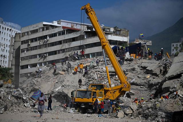 Rescue teams and volunteers search for bodies amid the rubble of a collapsed building in Caraballeda, Venezuela, on September 2, 2026. The magnitude 7.2 and 7.5 tremors on June 24, 2026, devastated the coastal state of La Guaira, where at least 190 buildings fell apart. Venezuela's interim government reported 6,509 deaths on August 24, 2026, exactly two months after the twin earthquakes. (Photo by Federico PARRA / AFP)