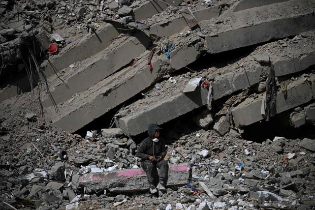 A man rests amid the rubble of buildings damaged by the June 24 earthquakes in Caraballeda, Venezuela, on September 2, 2026. The magnitude 7.2 and 7.5 tremors on June 24, 2026, devastated the coastal state of La Guaira, where at least 190 buildings fell apart. Venezuela's interim government reported 6,509 deaths on August 24, 2026, exactly two months after the twin earthquakes. (Photo by Federico PARRA / AFP)